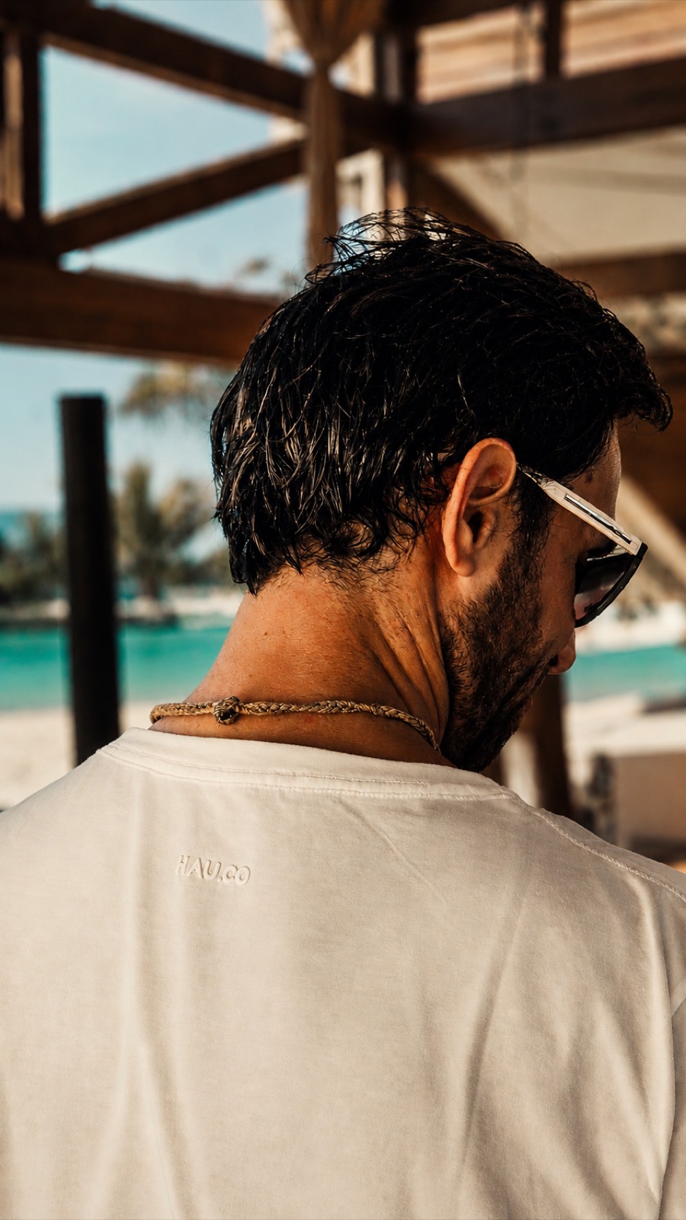 Erick Fontes de costas em uma praia